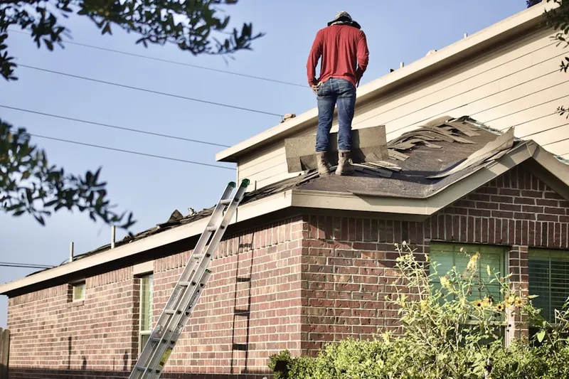 Professional roofer working on a residential roof in Westmoreland Hills